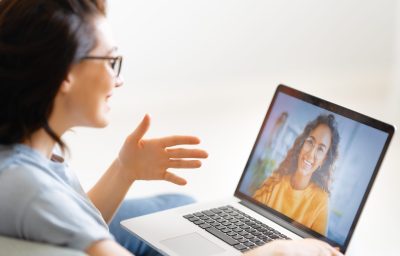 Young,Woman,Is,Using,Laptop,For,Remote,Conversation,With,Friend.